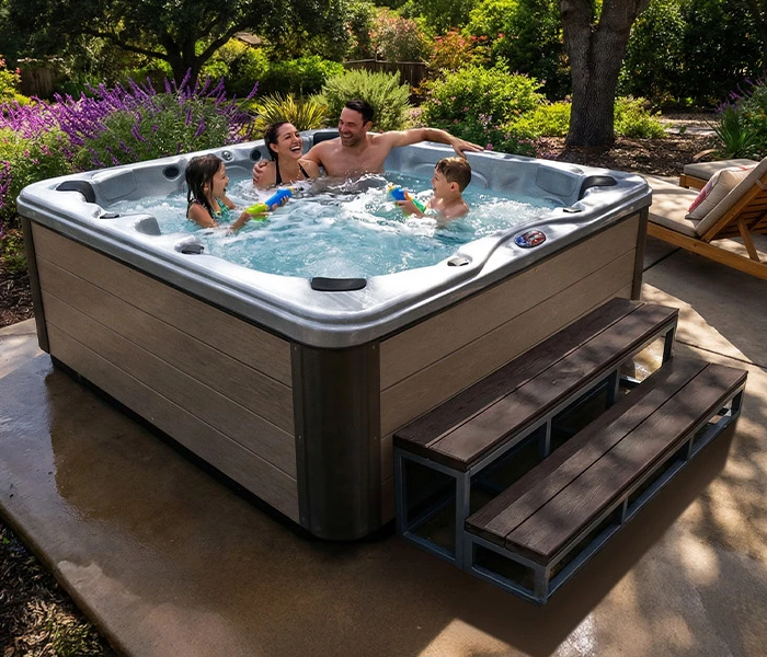 Hot Tubs, Spas, Portable Spas, for sale American Spas American Spas hot tub being used in a family setting
